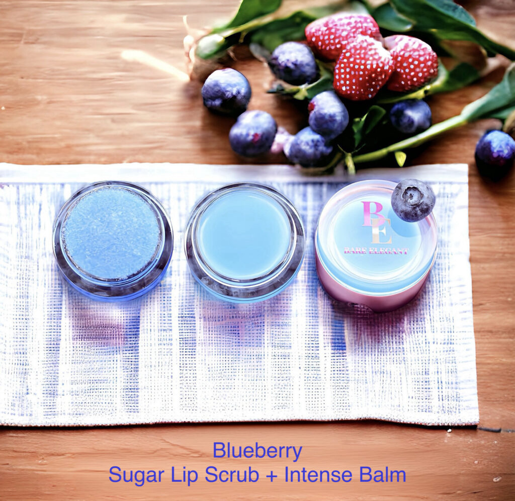 Blueberry sugar lip scrub and intense balm on a wooden table with berries.