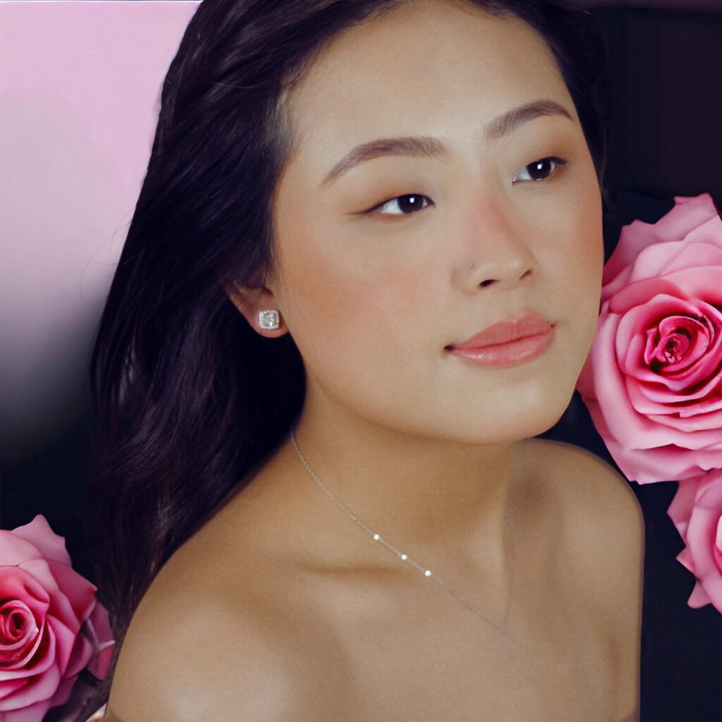 Portrait of a woman with soft makeup and pink roses.