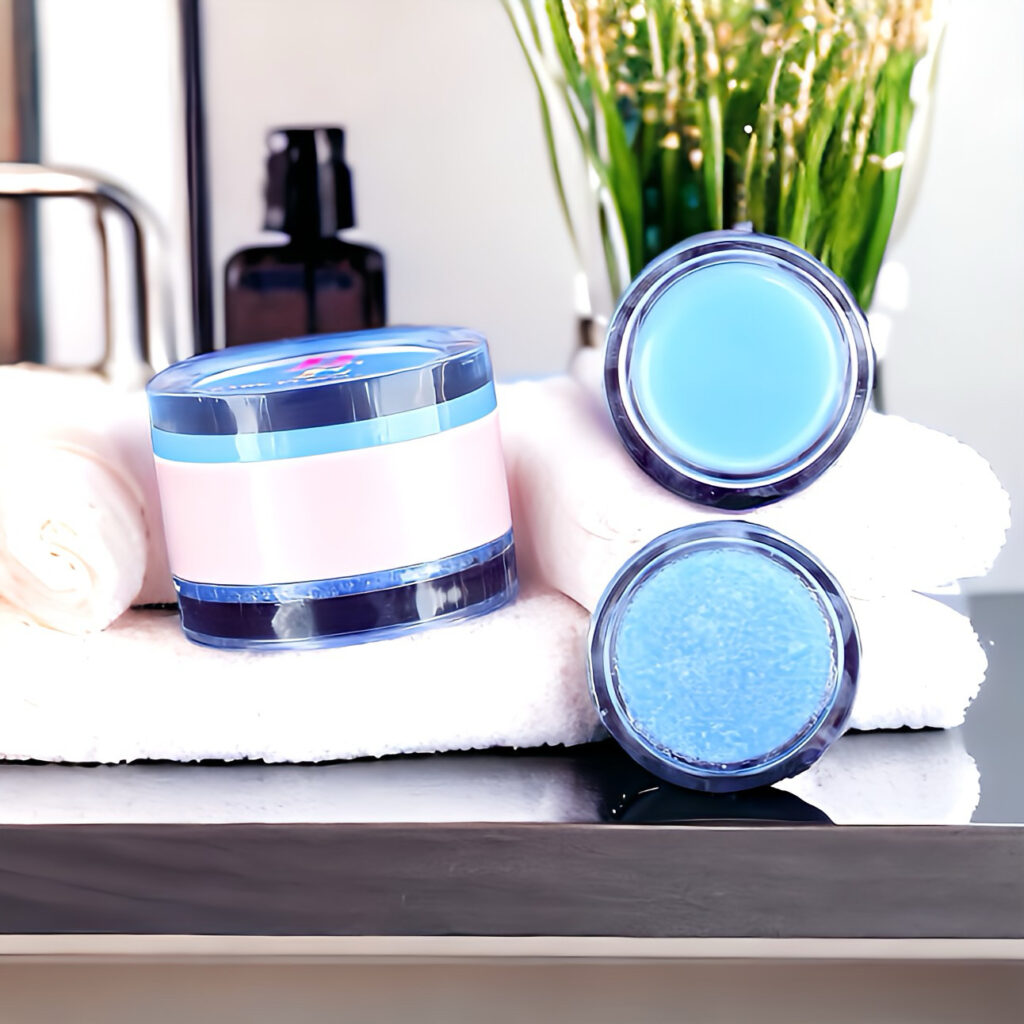 Skincare jars and towel arranged on a bathroom counter with a plant in the background.