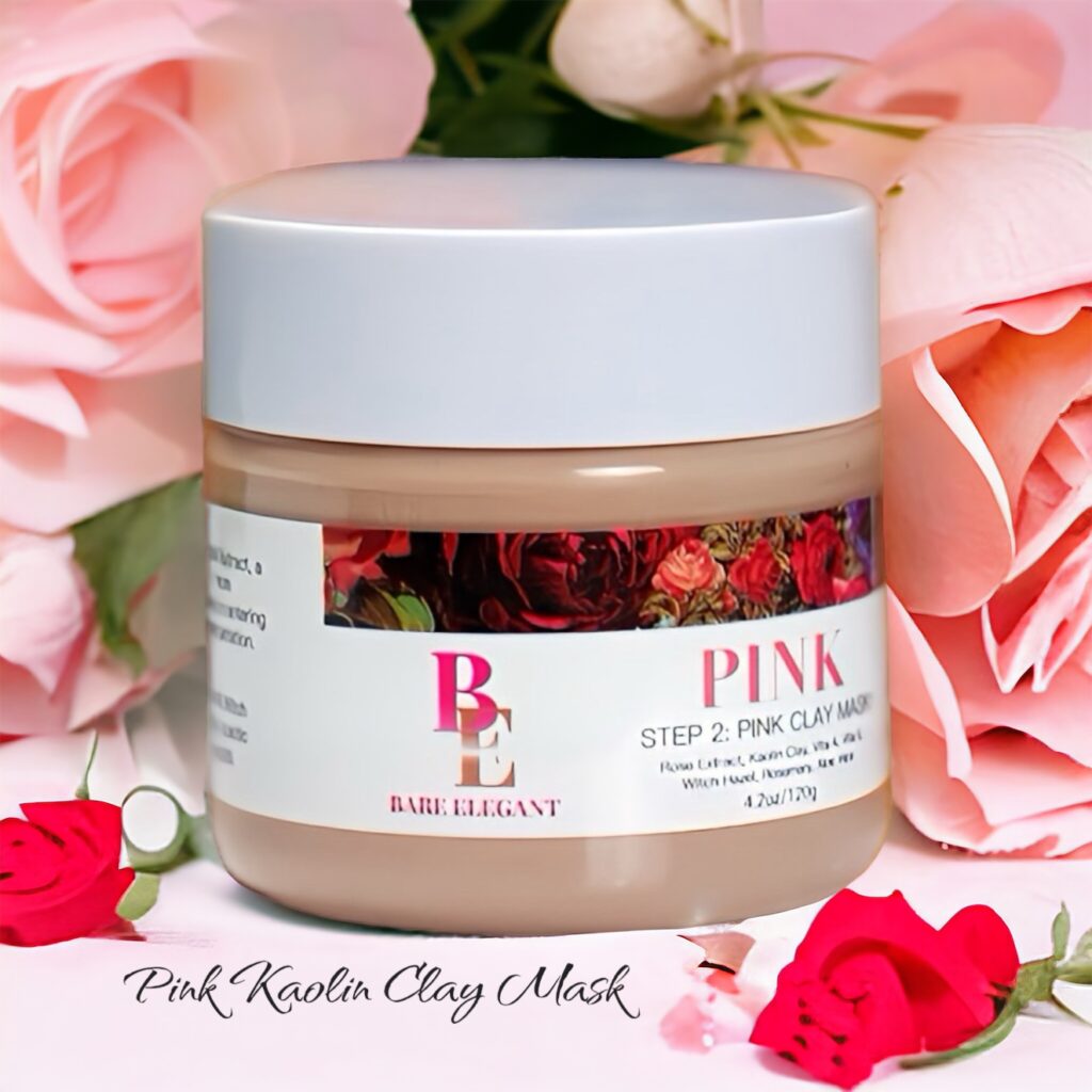 Jar of Pink Rosehip Clay Mask surrounded by pink roses.
