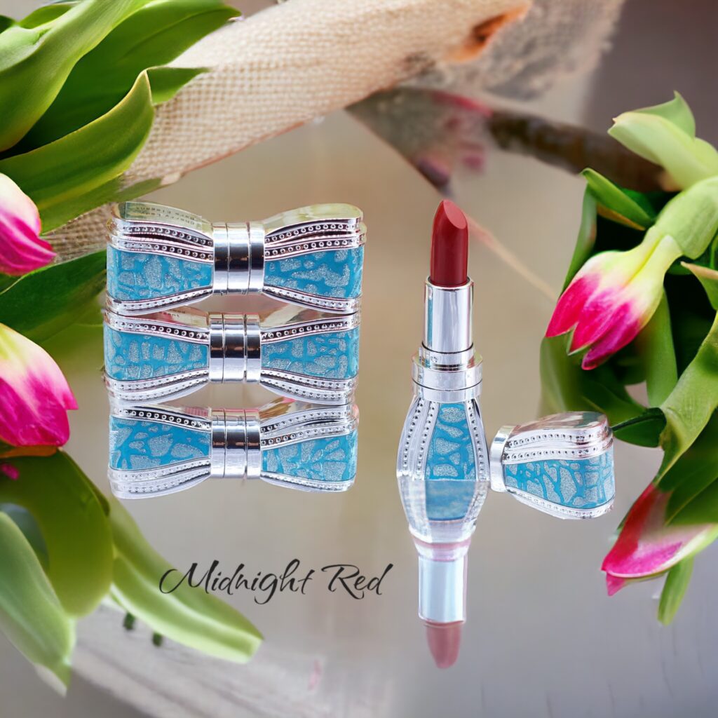 A lipstick with a blue bow-shaped case surrounded by pink tulips.