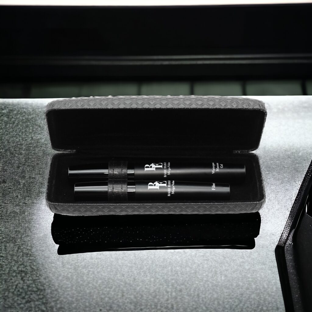 Two sleek vape pens in a black case placed on a reflective surface.