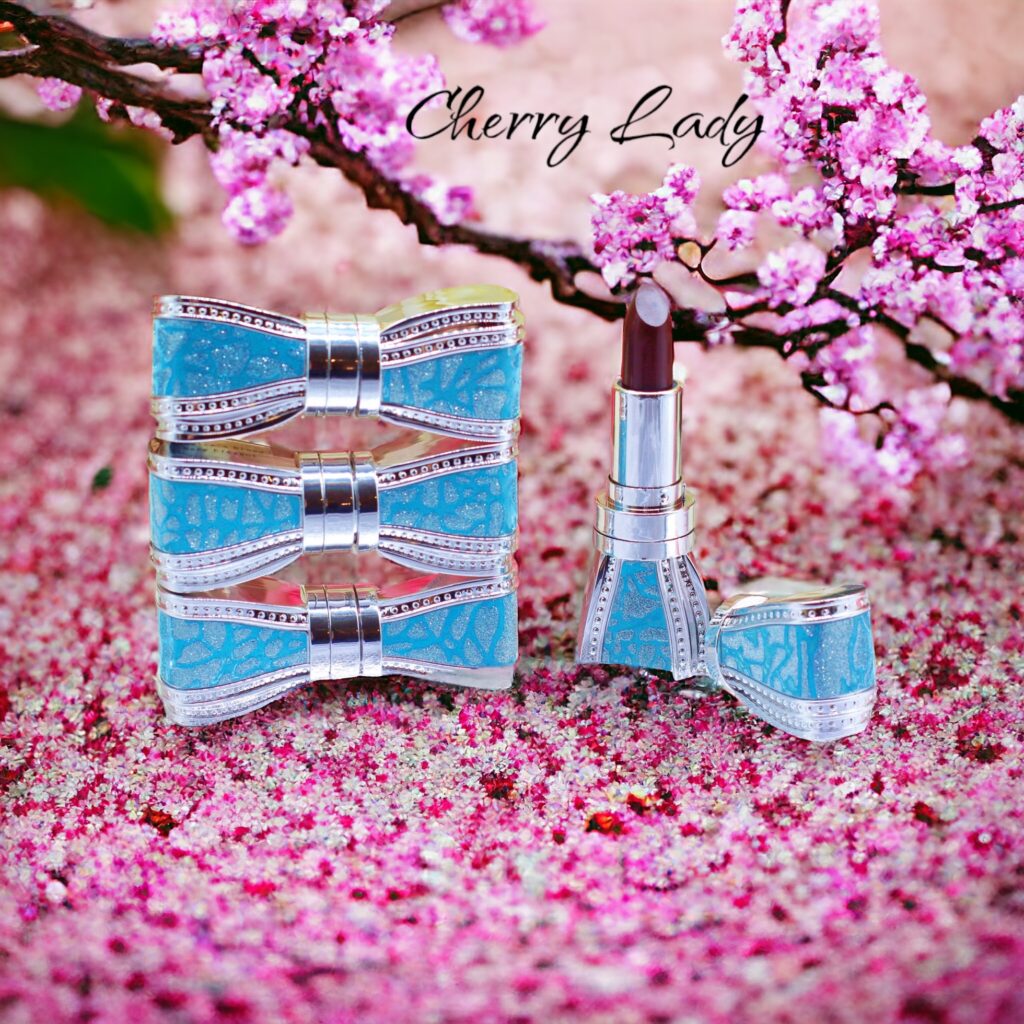 Elegant blue perfume set displayed on pink cherry blossom petals.