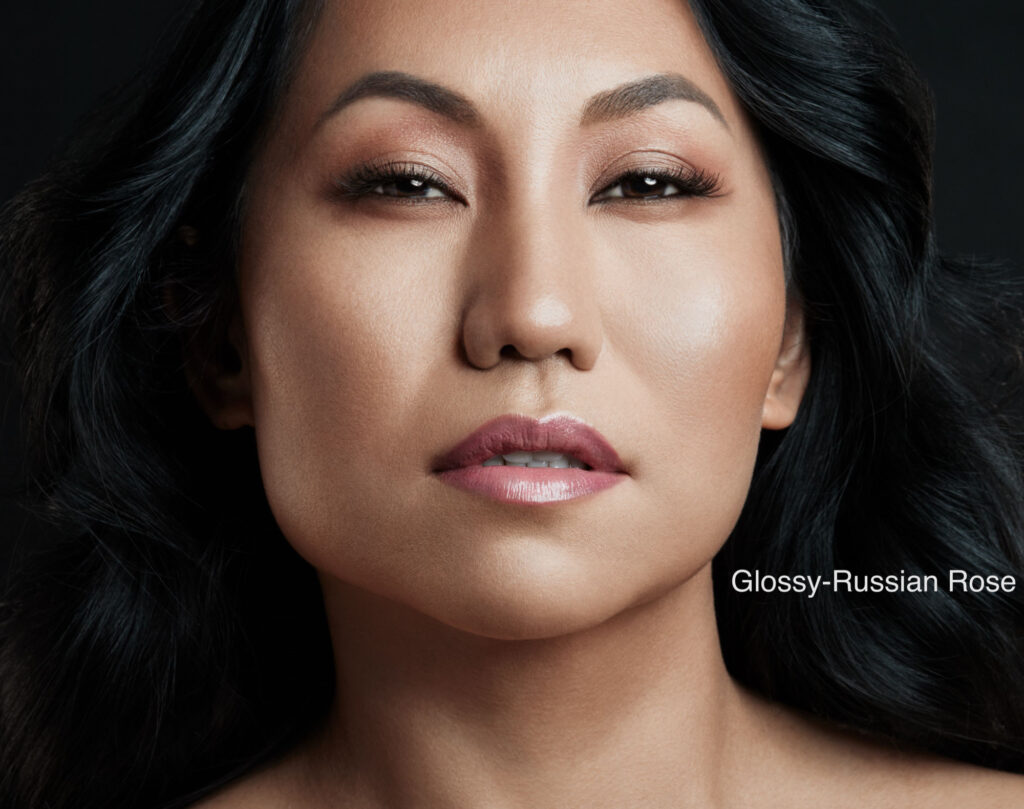 Close-up portrait of a woman with natural makeup and serene expression.