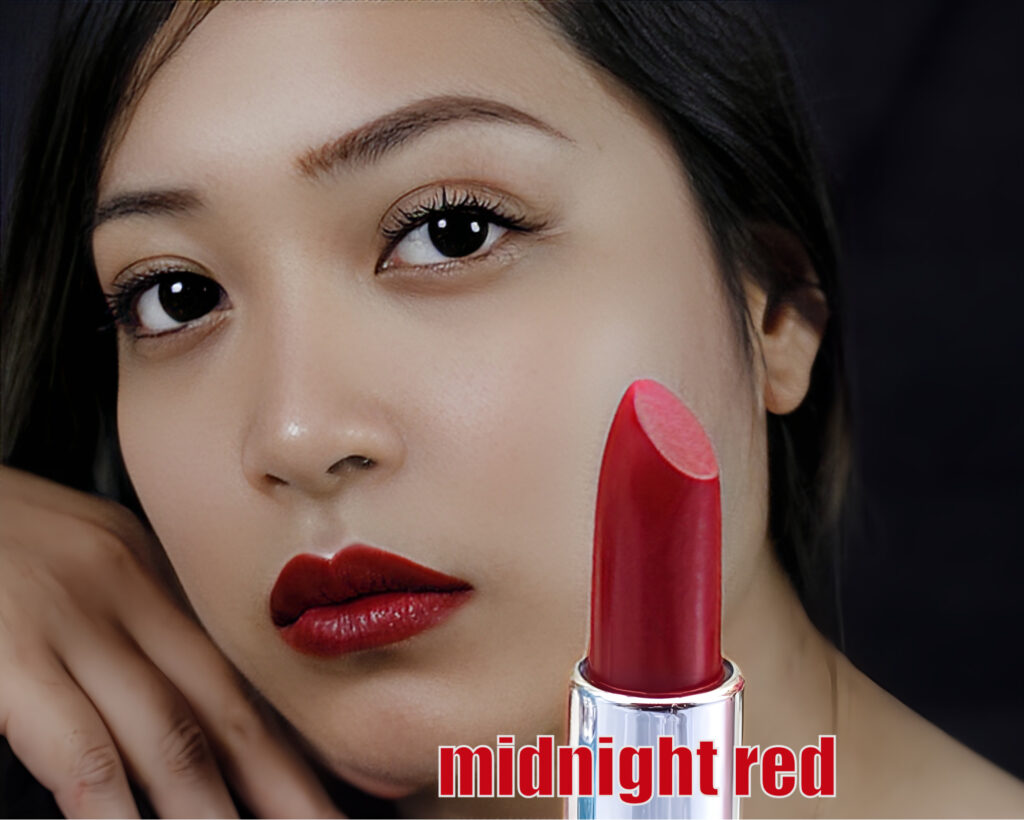Close-up of a woman wearing deep red lipstick called midnight red.