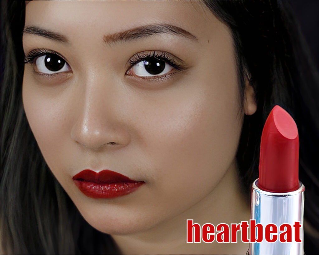Close-up of a woman with bold red lipstick and a matching red lipstick held near her face.